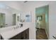 Bright bathroom with dark wood vanity, white countertop, and a large mirror at 21539 Gladis Ave, Port Charlotte, FL 33952