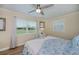 Cozy bedroom with ceiling fan, two windows, and comfortable bedding at 21539 Gladis Ave, Port Charlotte, FL 33952