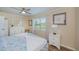 Charming bedroom with a ceiling fan, window, and a well-lit nightstand at 21539 Gladis Ave, Port Charlotte, FL 33952