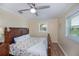 Bedroom with wood floor, windows, fan and starfish patterned comforter at 21539 Gladis Ave, Port Charlotte, FL 33952