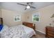 Bedroom with wood floor, windows, fan and starfish patterned comforter at 21539 Gladis Ave, Port Charlotte, FL 33952