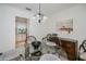 Elegant dining room with glass table, chandelier, and view to the kitchen at 21539 Gladis Ave, Port Charlotte, FL 33952