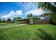 Inviting single-story home showcases a well-kept yard, secure fencing, and an attached garage, perfect for comfortable living at 21539 Gladis Ave, Port Charlotte, FL 33952