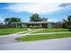 Inviting home features manicured lawn, well-kept landscaping, and a single-car garage at 21539 Gladis Ave, Port Charlotte, FL 33952