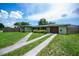 Charming home featuring a well-manicured lawn, a two-car garage and a quaint front garden at 21539 Gladis Ave, Port Charlotte, FL 33952