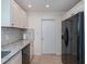 Kitchen with stainless steel appliances and modern white cabinets, plus tile backsplash at 21539 Gladis Ave, Port Charlotte, FL 33952