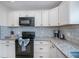 Bright kitchen features white cabinets, granite countertops, and stainless steel appliances at 21539 Gladis Ave, Port Charlotte, FL 33952