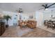 Cozy living room featuring hardwood floors, ceiling fans, and comfortable leather furniture at 21539 Gladis Ave, Port Charlotte, FL 33952