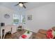 Office nook features two chairs, a desk, and a window with neighborhood views at 21539 Gladis Ave, Port Charlotte, FL 33952