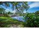 Beautiful waterfront pond view with clear sky and a bridge in the distance at 21539 Gladis Ave, Port Charlotte, FL 33952