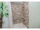 Shower with white brick-look accent, hand-held sprayer, and open shelf at 21539 Gladis Ave, Port Charlotte, FL 33952