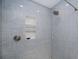 Modern shower featuring gray subway tile, niche shelving, and sleek fixtures at 21539 Gladis Ave, Port Charlotte, FL 33952