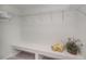 Walk-in closet with shelving and storage bench, offering organized space at 21539 Gladis Ave, Port Charlotte, FL 33952