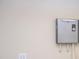 A wall mounted tankless water heater in neutral tones with an electrical outlet below at 21539 Gladis Ave, Port Charlotte, FL 33952