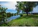 Lush greenery and mature trees line the waterfront of this beautiful property at 21539 Gladis Ave, Port Charlotte, FL 33952
