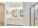 Bright bathroom featuring a double sink vanity and glass enclosed shower at 2308 Oberon Ln, Punta Gorda, FL 33983