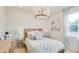 Bright bedroom with light blue accents, wooden headboard, and chandelier at 2308 Oberon Ln, Punta Gorda, FL 33983