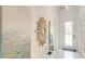 Light and airy entryway featuring a sunburst mirror and neutral decor at 2308 Oberon Ln, Punta Gorda, FL 33983