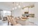 Bright kitchen with white cabinets, granite countertops, and stainless steel appliances at 2308 Oberon Ln, Punta Gorda, FL 33983