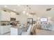 Modern kitchen with white cabinets, granite countertops, stainless appliances and bar seating at 2308 Oberon Ln, Punta Gorda, FL 33983