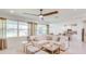 Comfortable living room featuring a large sectional couch, multiple windows and an open layout at 2308 Oberon Ln, Punta Gorda, FL 33983
