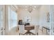 Bright office with a large window, a ceiling fan and modern furnishings at 2308 Oberon Ln, Punta Gorda, FL 33983