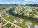 Stunning aerial view of a waterfront community with lush landscaping and beautiful canals in desirable neighborhood at 2309 Conway Blvd, Port Charlotte, FL 33952