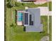 Aerial view showcasing a house with solar panels and a screened-in pool, plus canal access at 2309 Conway Blvd, Port Charlotte, FL 33952