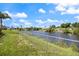 Fenced backyard with a canal view, provides security and scenic water views for outdoor enjoyment at 2309 Conway Blvd, Port Charlotte, FL 33952