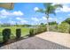 Backyard patio with a lake view, landscaping, and blue sky at 2309 Conway Blvd, Port Charlotte, FL 33952