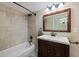 Bathroom featuring shower, tub, vanity, dark wood accents, and neutral walls at 2309 Conway Blvd, Port Charlotte, FL 33952