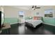 Bright bedroom with a double bed, neutral walls, ceiling fan, and wood flooring at 2309 Conway Blvd, Port Charlotte, FL 33952