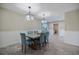 Dining area with wood-look flooring, neutral walls, and modern lighting at 2309 Conway Blvd, Port Charlotte, FL 33952