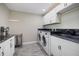 Modern laundry room featuring a washer and dryer and granite countertops at 2309 Conway Blvd, Port Charlotte, FL 33952