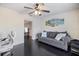 Comfortable living room with a gray sofa, accent pillows, and dark wood floors at 2309 Conway Blvd, Port Charlotte, FL 33952