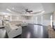 Bright living room featuring a sectional sofa, ceiling fan, and dark wood flooring at 2309 Conway Blvd, Port Charlotte, FL 33952