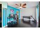 Home office with painted accent wall, dark wood floors, and ceiling fan at 2309 Conway Blvd, Port Charlotte, FL 33952