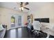 Bright office featuring dark wood floors, French doors and modern ceiling fan at 2309 Conway Blvd, Port Charlotte, FL 33952