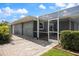 Patio area with a screened in lanai and an access gate to the rest of the property at 2309 Conway Blvd, Port Charlotte, FL 33952