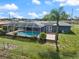 The backyard has a beautiful screened pool with brick patio, with views of a palm tree at 2309 Conway Blvd, Port Charlotte, FL 33952