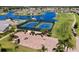 Aerial view of the community's tennis courts, golf course, water feature, and cart parking at 24132 Buckingham Way, Punta Gorda, FL 33980