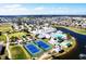 Stunning aerial view of community amenities including a pool, tennis courts, and a clubhouse at 24132 Buckingham Way, Punta Gorda, FL 33980
