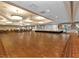 Large ballroom with hardwood floors, stage, and elegant lighting perfect for hosting events and gatherings at 24132 Buckingham Way, Punta Gorda, FL 33980
