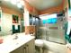 Charming bathroom featuring a shower-tub combo, vanity with storage, and tropical accents at 24132 Buckingham Way, Punta Gorda, FL 33980