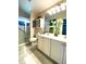 Well-lit bathroom featuring a glass-enclosed shower, vanity with storage, and neutral color palette at 24132 Buckingham Way, Punta Gorda, FL 33980
