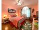 Warm and inviting bedroom with natural light, complemented by hardwood floors and cozy decor at 24132 Buckingham Way, Punta Gorda, FL 33980