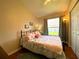Cozy bedroom with natural light, complemented by hardwood floors and closet with mirrored doors at 24132 Buckingham Way, Punta Gorda, FL 33980