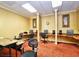 Functional business center with multiple computer workstations, chairs, and a conference table for meetings at 24132 Buckingham Way, Punta Gorda, FL 33980