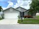 Charming single-story home with well-maintained landscaping and an attached two-car garage at 24132 Buckingham Way, Punta Gorda, FL 33980
