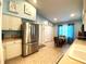 Bright eat-in kitchen with stainless steel appliances and adjacent dining area with natural light at 24132 Buckingham Way, Punta Gorda, FL 33980